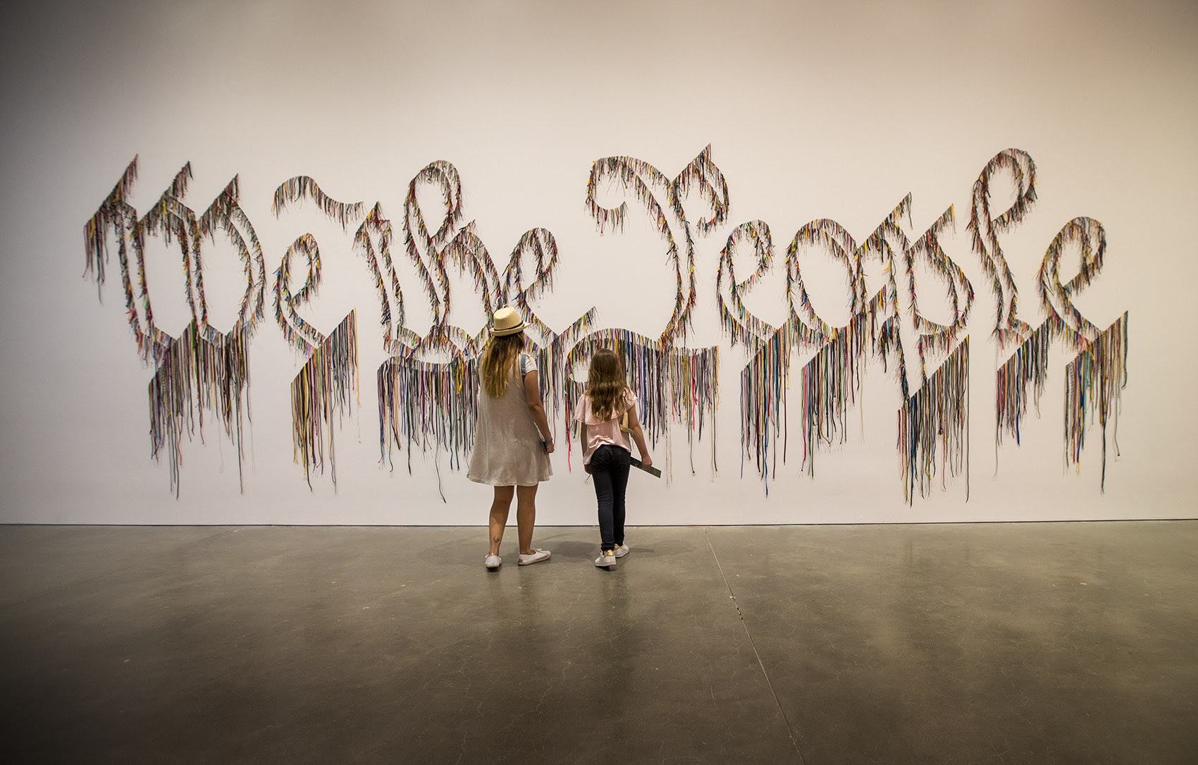 Visitors approach Nari Ward's &quot;We the People&quot; at the ICA. (Jesse Costa/WBUR)