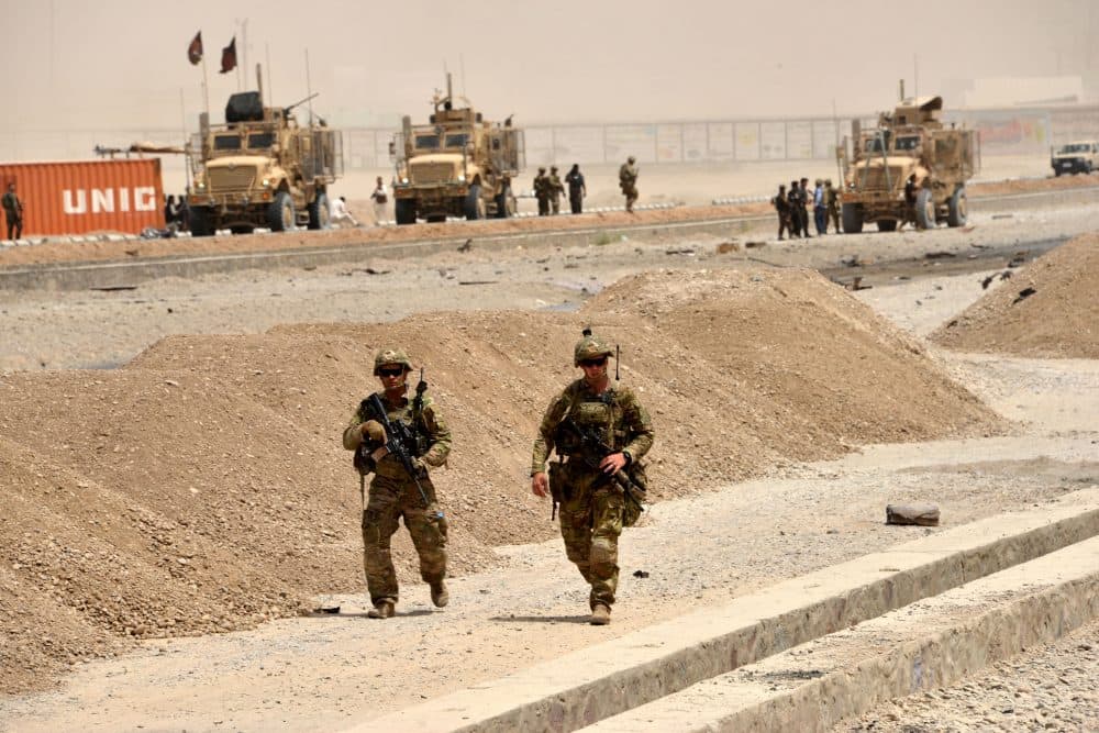 U.S. soldiers walk at the site of a Taliban suicide attack in Kandahar on Aug. 2, 2017. A Taliban suicide bomber on Aug. 2 rammed a vehicle filled with explosives into a convoy of foreign forces in Afghanistan's restive southern province of Kandahar, causing casualties, officials said. (Javed Tanveer/AFP/Getty Images)
