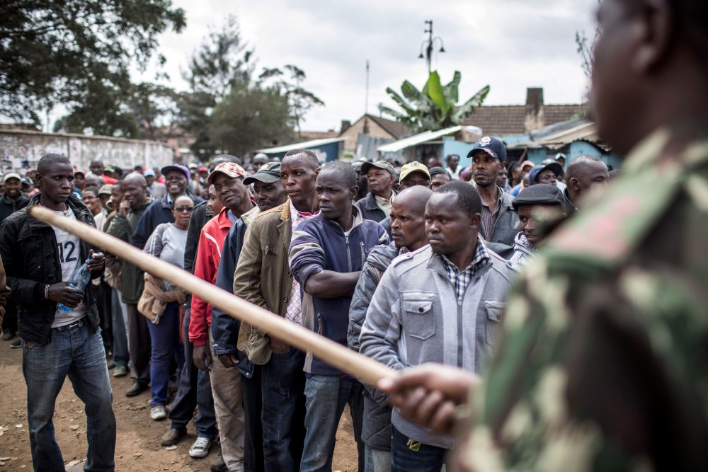 A Kenya Administration police officer holding a stick monitors access to a polling station at Kariokor Community Centre in Nairobi on Aug. 8, 2017 during general elections. Kenyans were voting in elections headlined by a knife-edge battle between incumbent Uhuru Kenyatta and his rival Raila Odinga that has sent tensions soaring in East Africa's richest economy. (Luis Tato/AFP/Getty Images)