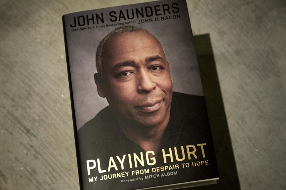 &quot;Playing Hurt,&quot; by John Saunders, with John U. Bacon. (Robin Lubbock/WBUR)