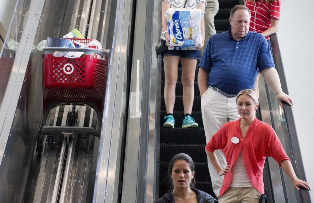In this Aug. 21, 2015 photo, shoppers ride an escalator beside a special one for shopping carts in the CityTarget store in Boston. (Michael Dwyer/AP)