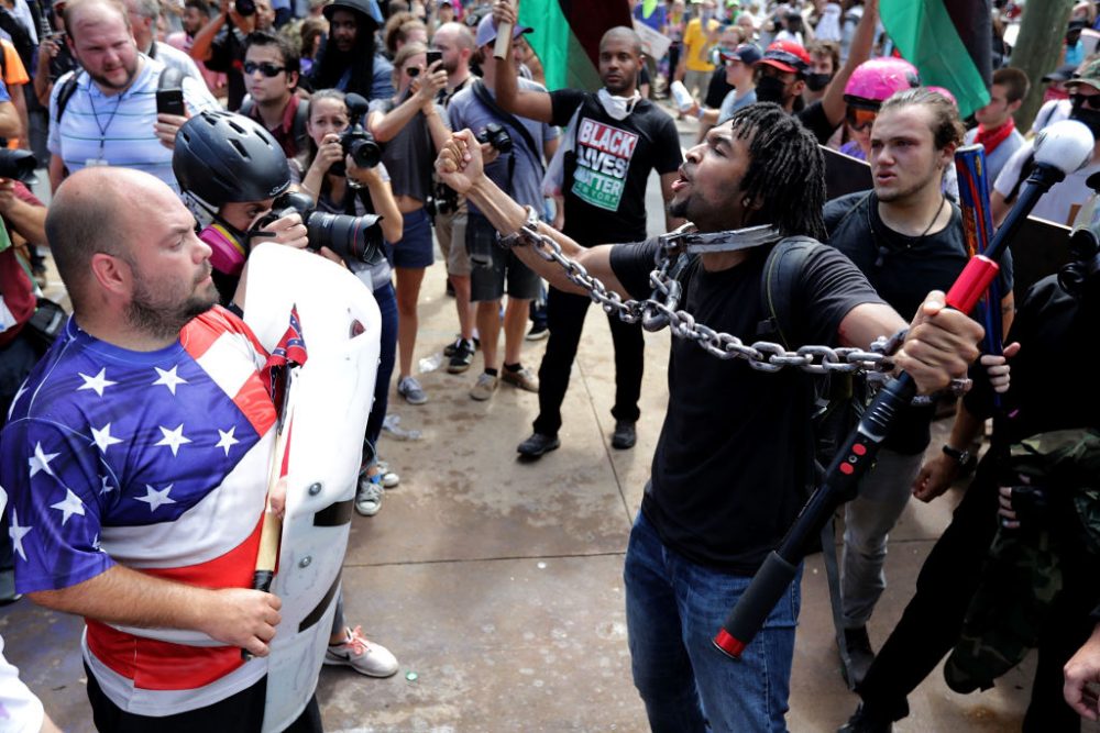 White nationalists, neo-Nazis and members of the 'alt-right' exchange insluts with counter-protesters as they attempt to guard the entrance to Emancipation Park during the 'Unite the Right' rally Aug. 12, 2017 in Charlottesville, Va. After clashes with anti-fascist protesters and police the rally was declared an unlawful gathering and people were forced out of Emancipation Park, where a statue of Confederate General Robert E. Lee is slated to be removed. (Chip Somodevilla/Getty Images)