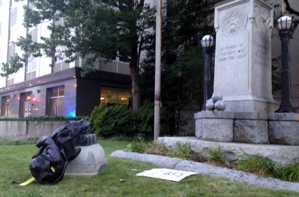 A toppled Confederate statue lies on the ground on Monday, Aug. 14, 2017, in Durham, N.C. Activists on Monday evening used a rope to pull down the monument outside a Durham courthouse. The Durham protest was in response to a white nationalist rally held in Charlottesville, Va, over the weekend. (Jonathan Drew/AP)