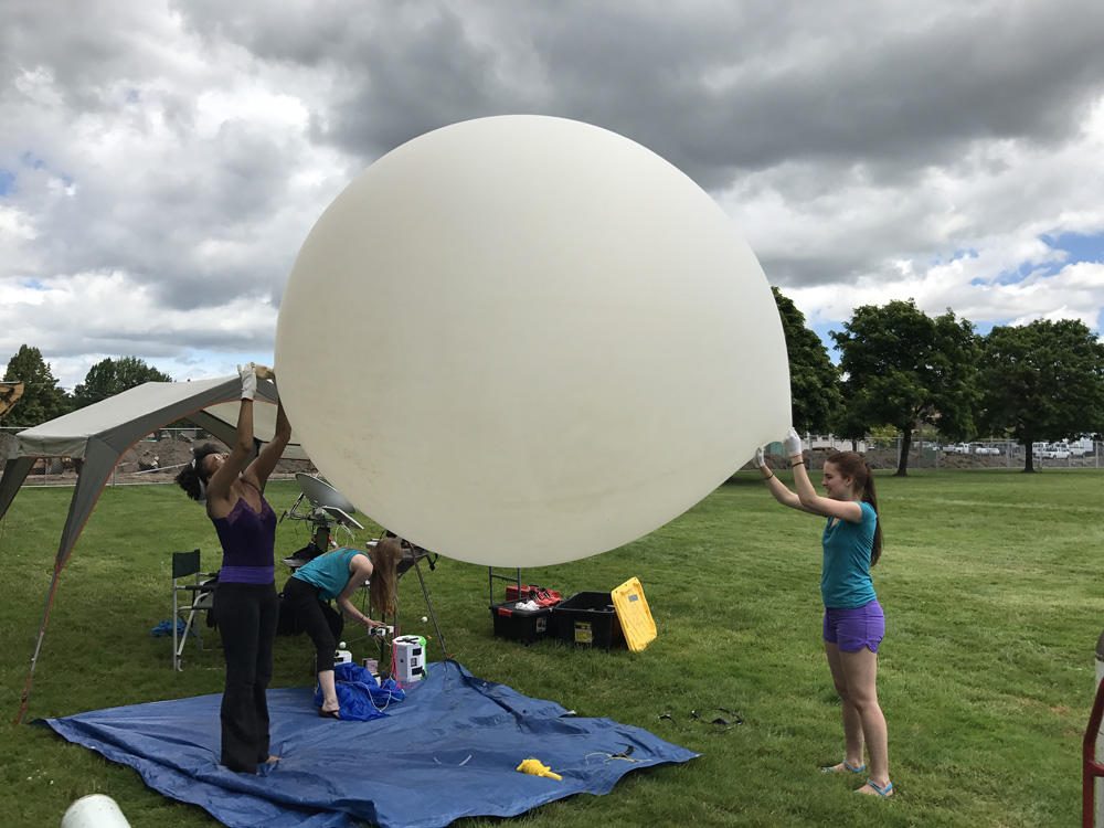 Earlier this summer, PSU students Rihana Mungin (from left), Harmony Ewing and Olea Stevens tested the type of weather balloon they'll use for the NASA-funded Eclipse Ballooning Project on Aug. 21. (Portland State University)