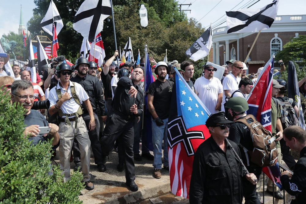 Hundreds of white nationalists, neo-Nazis, KKK and members of the &quot;alt-right&quot; hurl water bottles back and forth against counter demonstrators on the outskirts of Emancipation Park during the Unite the Right rally Aug. 12, 2017 in Charlottesville, Va. (Chip Somodevilla/Getty Images)