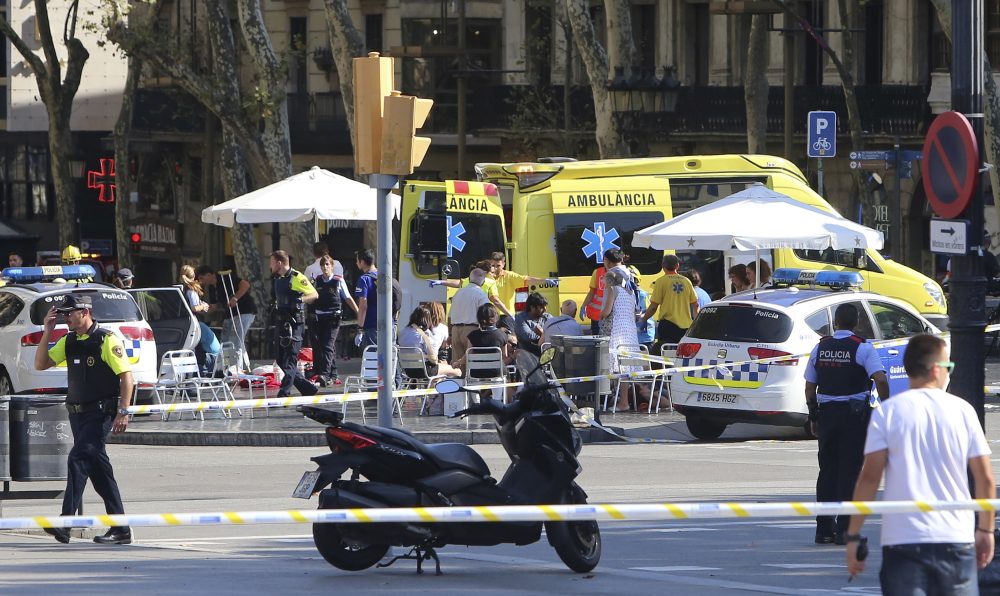 Injured people are treated in Barcelona, Spain, Thursday, Aug. 17, 2017 after a white van jumped the sidewalk in the historic Las Ramblas district, crashing into a summer crowd of residents and tourists and injuring several people, police said. (Oriol Duran/AP)