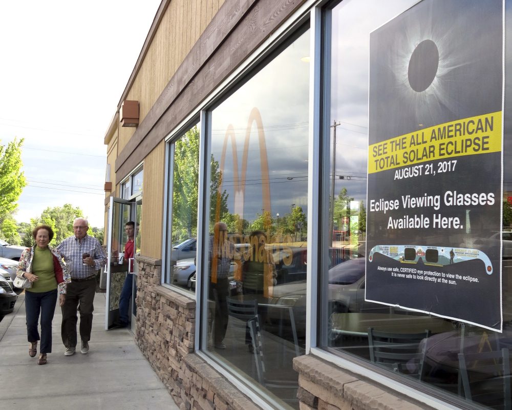 A poster advertising the Aug. 21 total solar eclipse hangs in the window of a McDonald's restaurant in Madras, Oregon on June 12, 2017. (Gillian Flaccus/AP)