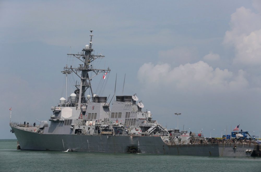 The guided-missile destroyer USS John S. McCain (DDG 56) is moored pier side at Changi naval base in Singapore following a collision with the merchant vessel Alnic MC Monday, Aug. 21, 2017. The USS John S. McCain was docked at Singapore's naval base with &quot;significant damage&quot; to its hull after an early morning collision with the Alnic MC as vessels from several nations searched Monday for missing U.S. sailors. (Grady T. Fontana/U.S. Navy photo via AP)