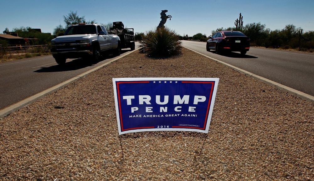 Motorists pass a campaign sign for then-Republican presidential candidate Donald Trump and vice presidential running mate Mike Pence posted in the center median of a roadway near a polling station on Nov. 8, 2016, in Cave Creek, Ariz. (Ralph Freso/Getty Images)