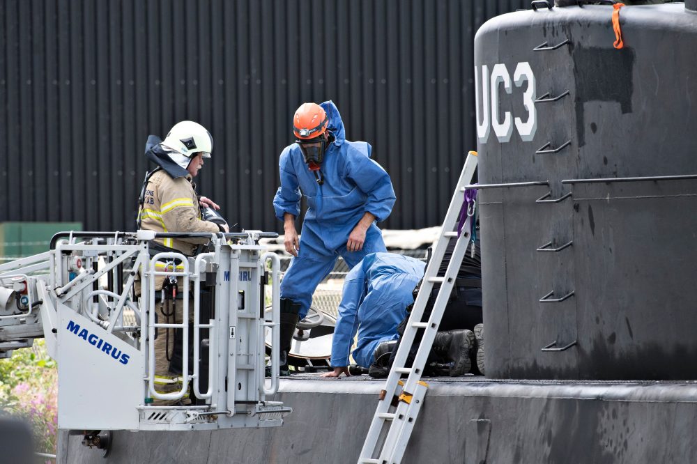 Police technicians investigate the rescued private-owned submarine UC3 Nautilus on Aug. 13, 2017 in Copenhagen Habor. Danish police said Sunday they searched a huge DIY submarine that sank last week in the hunt for a missing journalist who had been aboard before it sank, but no body was found. (Jens Noergaard Larsen/AFP/Getty Images)