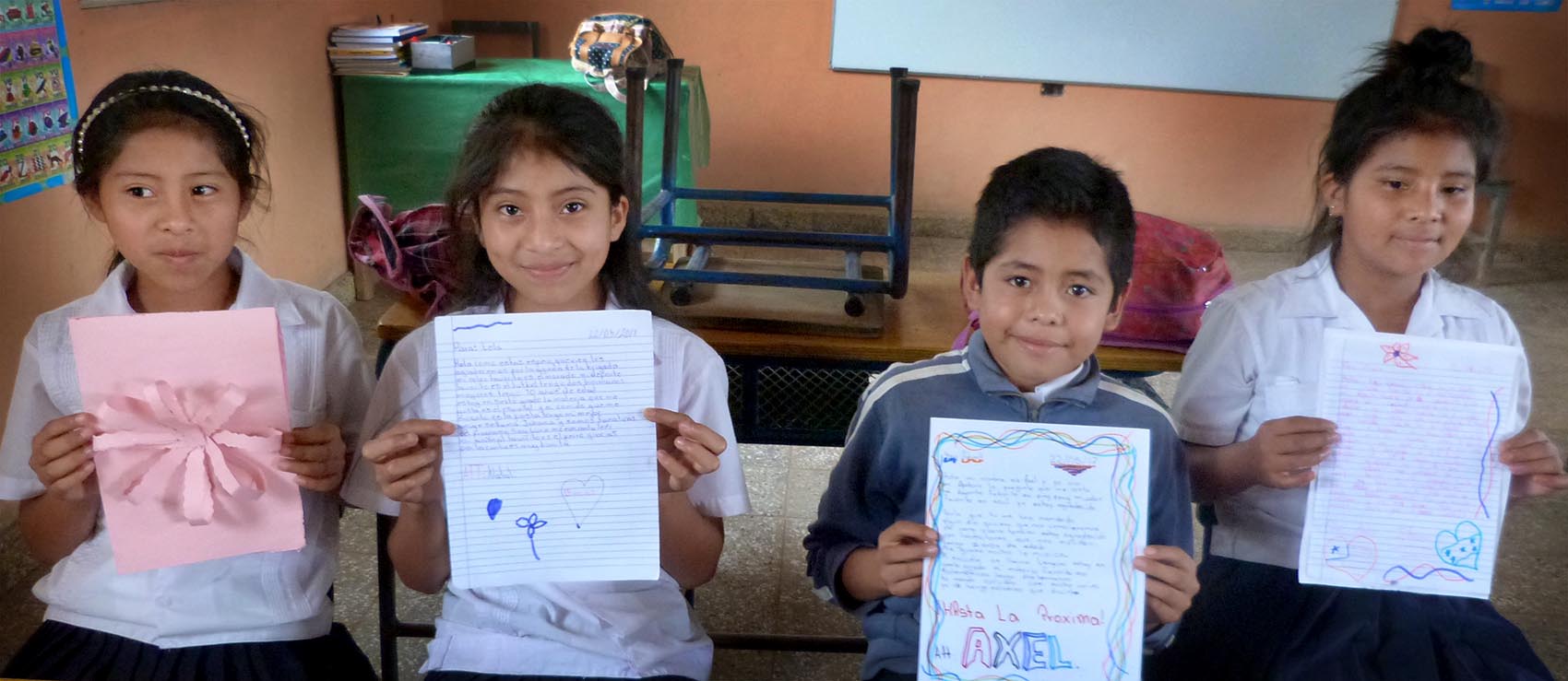 Lempira Elementary School students display their pen pal letter replies to Newtown students. (Karyn Miller-Medzon/Here & Now)