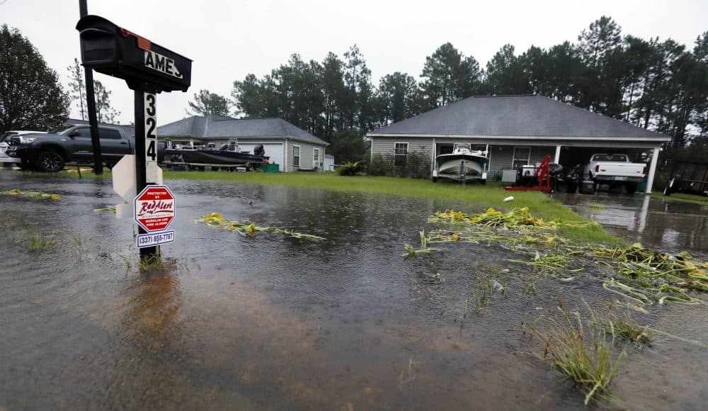 Rising waters threaten homes along North Perkins Ferry Road in Moss Bluff, La., near Lake Charles, La., as a constant rain from Harvey falls. (AP Photo/Rogelio V. Solis)