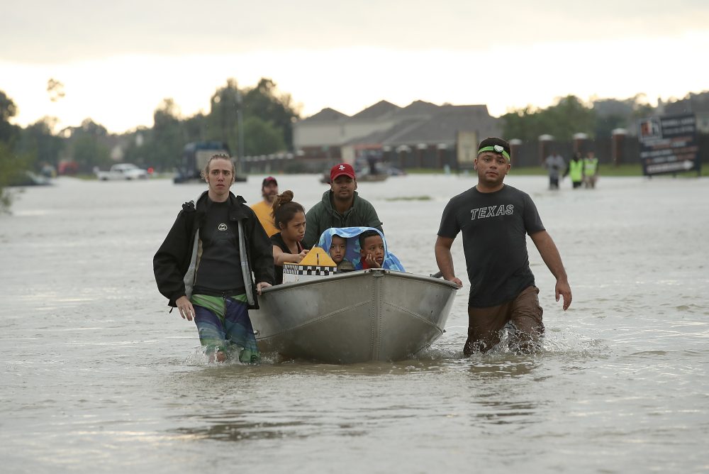 The Tellez family is evacuated from their home after severe flooding following Hurricane Harvey in north Houston Aug. 29, 2017. (Win McNamee/Getty Images)