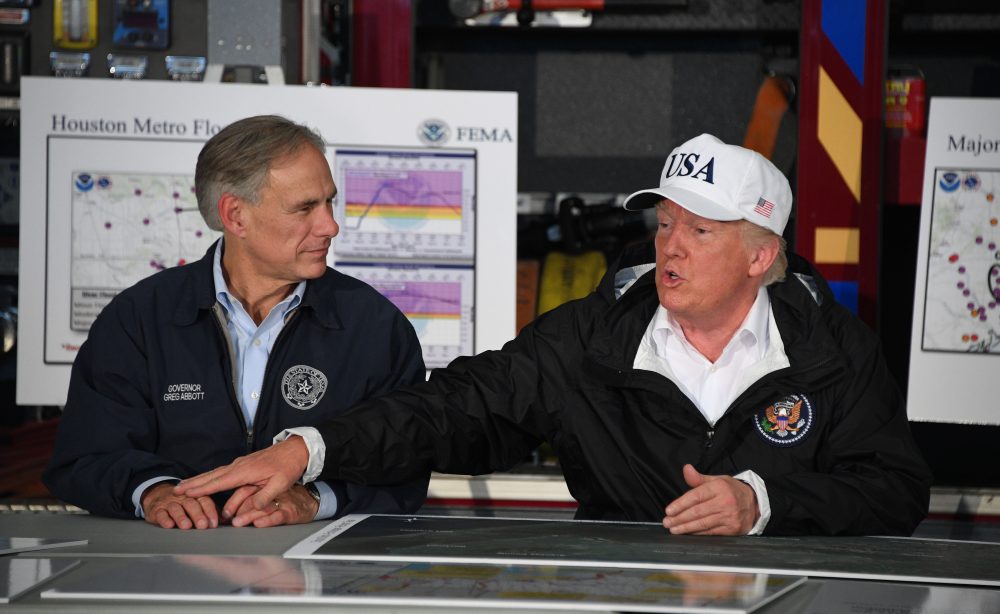 President Donald Trump (right) sits with Texas Gov. Greg Abbott during a briefing on Hurricane Harvey in Corpus Christi, Texas on Aug. 29, 2017. (Jim Watson/AFP/Getty Images)