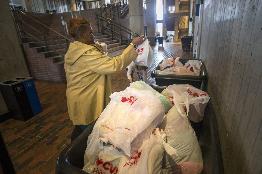 Rhonda Perch, of Hyde Park, drops off supplies at Boston City Hall for the flood victims of Hurricane Harvey in Houston, Texas. (Jesse Costa/WBUR)