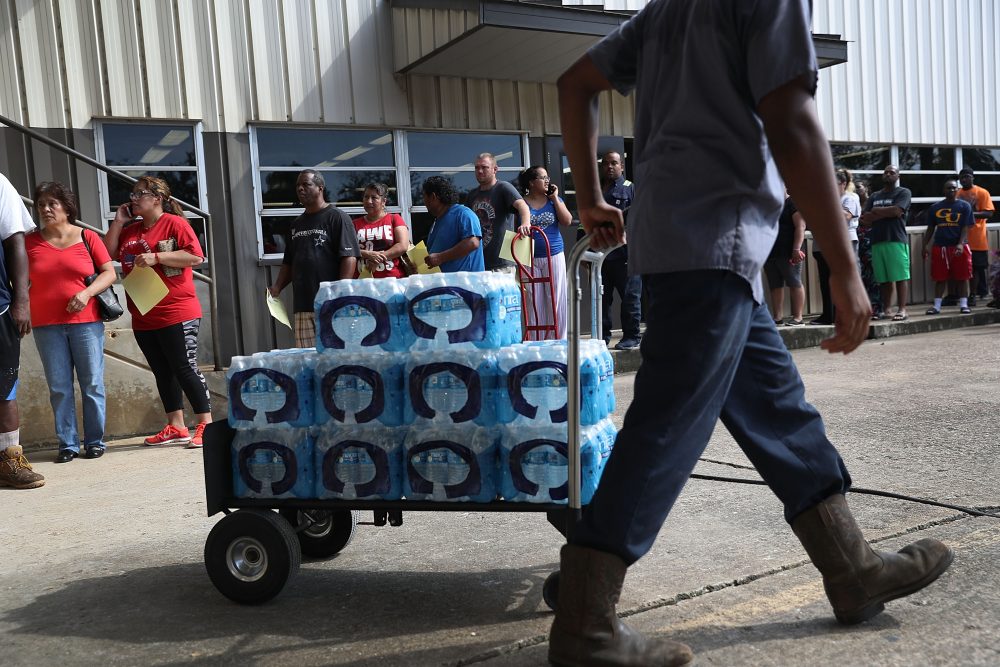 People wait in line to buy water at the Coastal Industrial and Specialty gas welding supplies store after the water supply to the city of Beaumont was shut down after Hurricane Harvey passed through on Aug. 31, 2017 in Beaumont, Texas. (Joe Raedle/Getty Images)