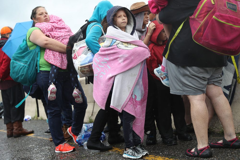 Evacuees wait to be transported to a shelter after being rescued from the flooding of Hurricane Harvey on Aug. 30, 2017 in Port Arthur, Texas. (Joe Raedle/Getty Images)