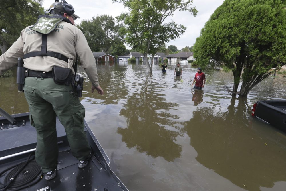 U.S. Border Patrol Agent Steven Blackburn, left, checks if people wading in water need help during a search a rescue operation in a neighborhood inundated by floodwaters from Tropical Storm Harvey in Houston, Texas, Wednesday, Aug. 30, 2017. (LM Otero/AP)