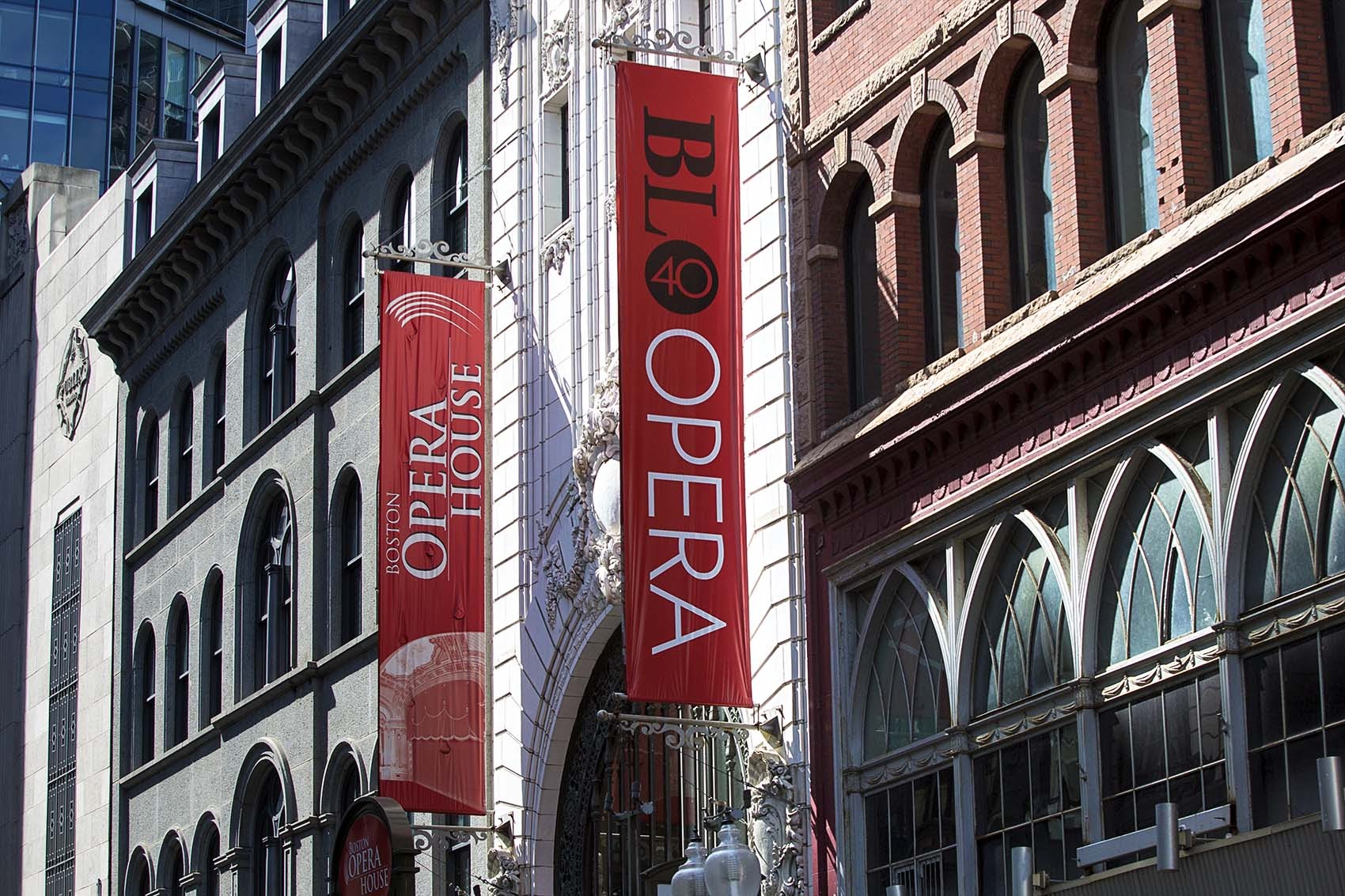 Banners for the Boston Lyric Opera hang outside the Boston Opera House last year. (Jesse Costa/WBUR)