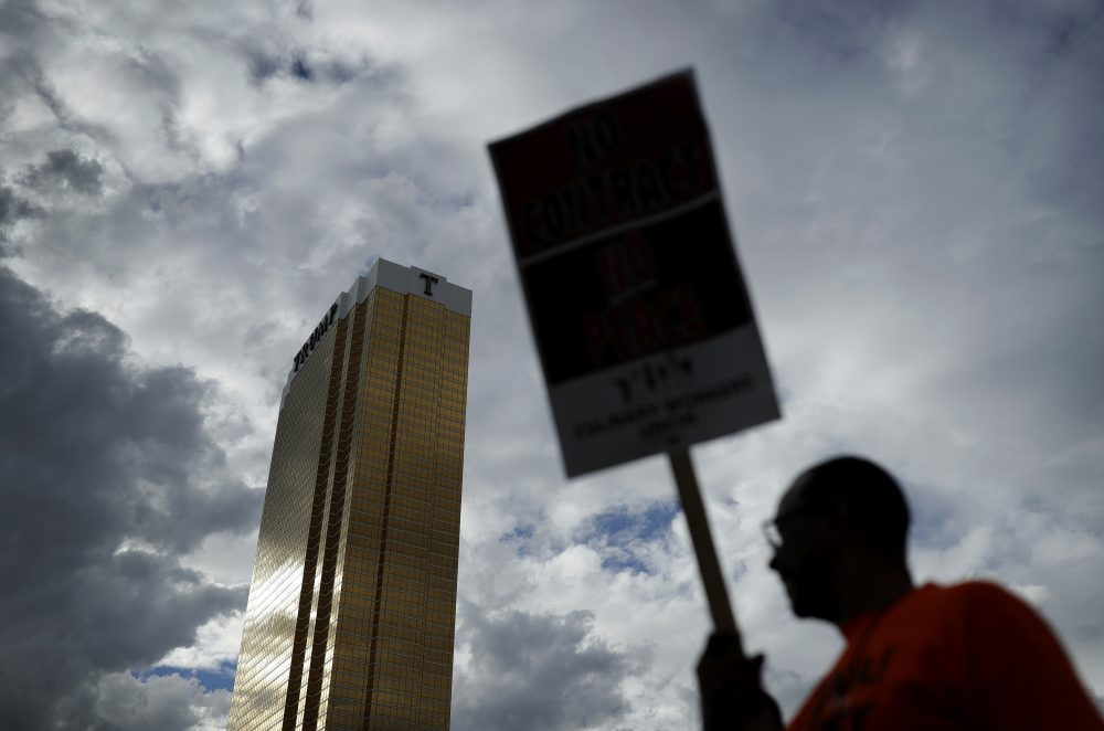 In this Sept. 21, 2016 file photo Laborers' International Union of North America members and Culinary Union members protest outside of the Trump International hotel in Las Vegas. (John Locher/ AP)