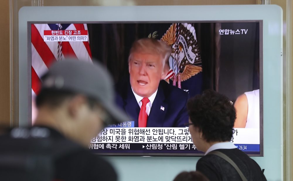 People walk by a TV screen showing a local news program reporting with an image of U.S. President Donald Trump at the Seoul Train Station in Seoul, South Korea, Wednesday, Aug. 9, 2017. North Korea and the United States traded escalating threats, with President Donald Trump threatening Pyongyang &quot;with fire and fury like the world has never seen&quot; and the North's military claiming Wednesday it was examining its plans for attacking Guam. (Lee Jin-man/AP)