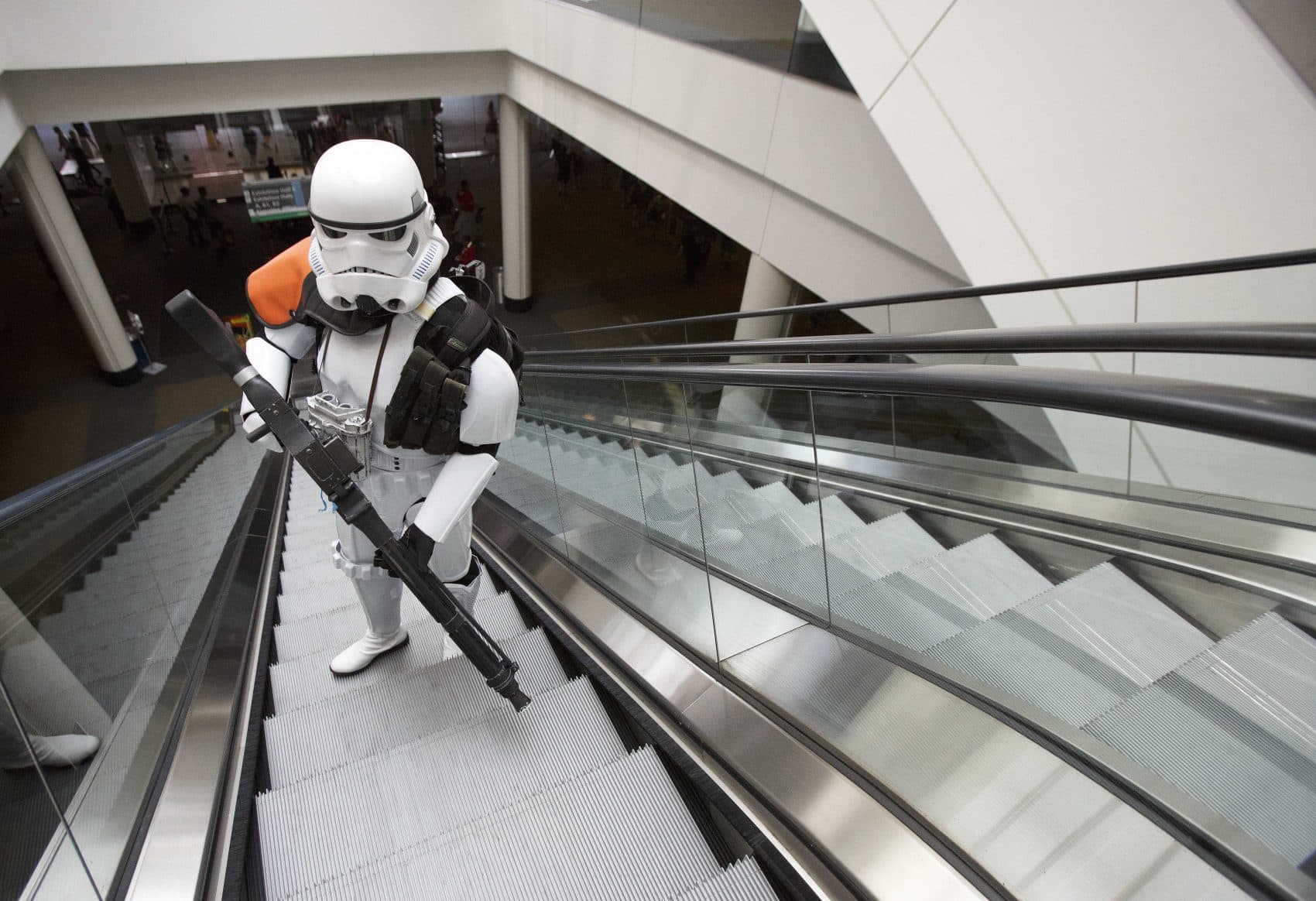 Heindrich Kuhlmann, of Brookline, Mass., rides an escalator dressed as a Star Wars stormtrooper on Friday. The convention was held at the Boston Convention & Exhibition Center through Sunday, August 13th. (AP Photo/Michael Dwyer)