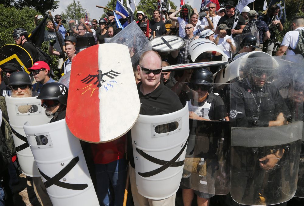 White nationalist demonstrators use shields as they guard the entrance to Lee Park in Charlottesville, Va., Saturday, Aug. 12, 2017. (Steve Helber/AP)