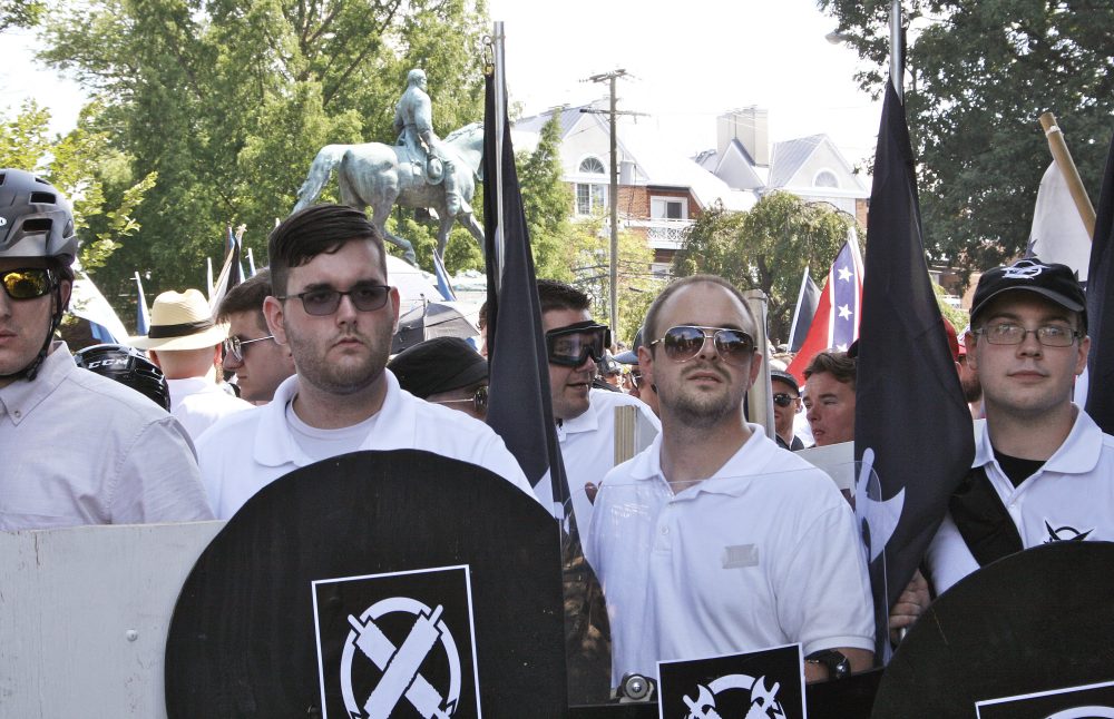 James Alex Fields Jr., second from left, holds a black shield in Charlottesville, Va., where a white supremacist rally took place. Fields, who was the driver in a deadly car attack at the Charlottesville rally, was sentenced to life in prison. (Alan Goffinski/AP)