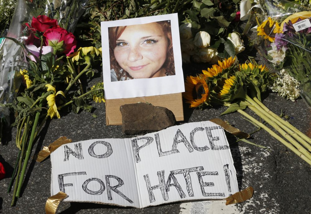 A makeshift memorial of flowers and a photo of victim, Heather Heyer, sits in Charlottesville, Va., Sunday, Aug. 13, 2017. Heyer died when a car rammed into a group of people who were protesting the presence of white supremacists who had gathered in the city for a rally. (Steve Helber/AP)