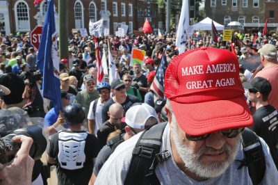 A white nationalist demonstrator walks into Lee Park in Charlottesville, Va., Saturday, Aug. 12, 2017. Hundreds of people chanted, threw punches, hurled water bottles and unleashed chemical sprays on each other Saturday after violence erupted at a white nationalist rally in Virginia. (Steve Helber/AP)