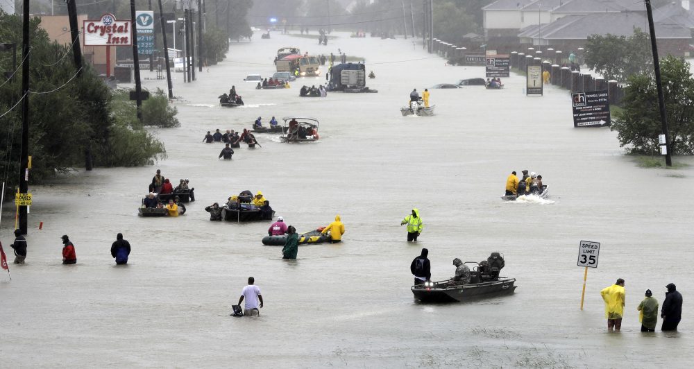 Rescue boats fill a flooded street as flood victims are evacuated as floodwaters from Tropical Storm Harvey rise Monday, Aug. 28, 2017, in Houston. (David J. Phillip/ AP)