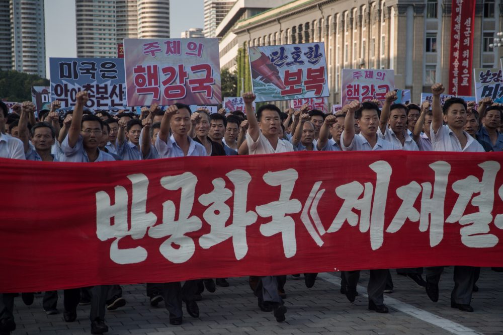 People wave banners and shout slogans as they attend a rally in support of North Korea's stance against the U.S., in Pyongyang on Aug. 9, 2017. (Kim Won-Jin/AFP/Getty Images)