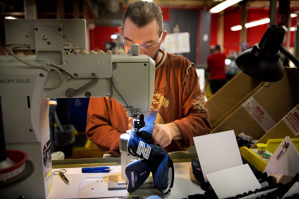 A New Balance factory worker assembling a running shoe. (Jesse Costa/WBUR)