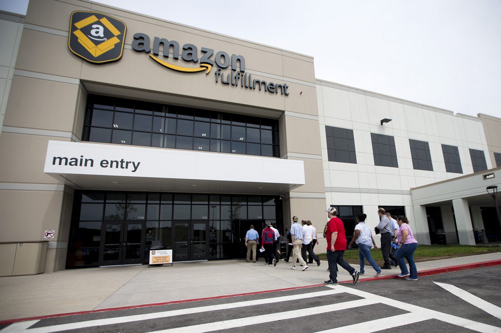A tour group of Amazon job seekers enters the front door of the Amazon Fulfillment Center in Fall River. (Jesse Costa/WBUR)