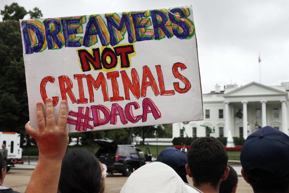 In this Aug. 15, 2017, file photo, a woman holds up a sign in support of the Obama administration program known as Deferred Action for Childhood Arrivals, or DACA, during an immigration reform rally at the White House in Washington. After months of delays, President Donald Trump is expected to decide soon on the fate of so called “dreamers” who were brought into the country illegally as children as he faces a looming court deadline and is digging in on appeals to his base. (Jacquelyn Martin/AP)