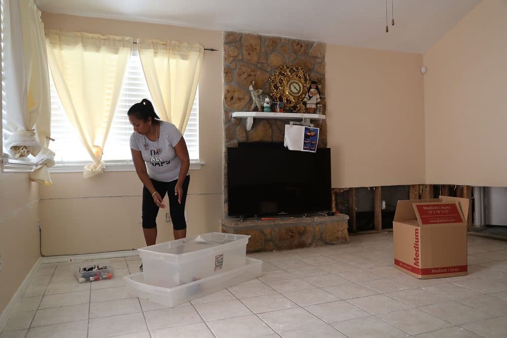 Sally Lacour cleans out her home after it was inundated with water after torrential rains caused widespread flooding during Hurricane and Tropical Storm Harvey on Sept. 2, 2017, in Houston. (Joe Raedle/Getty Images)