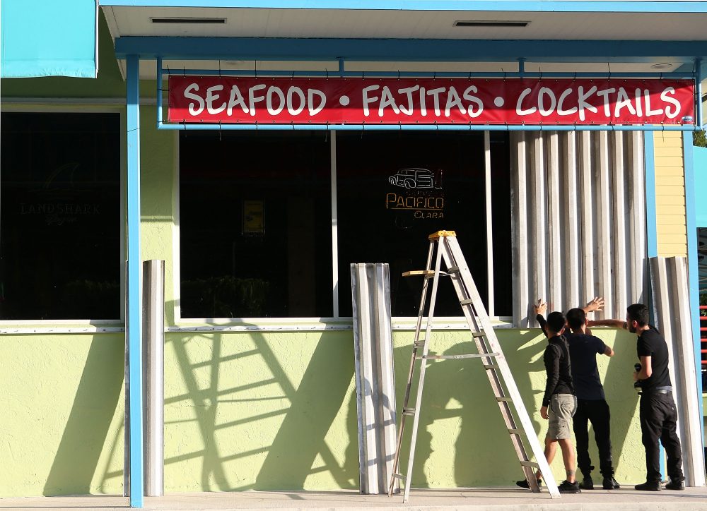 Workers install hurricane shutters on the Puerto Villarta restuarant on Overseas Highway in the Florida Keys on Sept. 5, 2017 in Islamorada, Fla. Residents are evacuating ahead of Hurricane Irma, a powerful storm expected to make landfall this weekend. (Marc Serota/Getty Images)