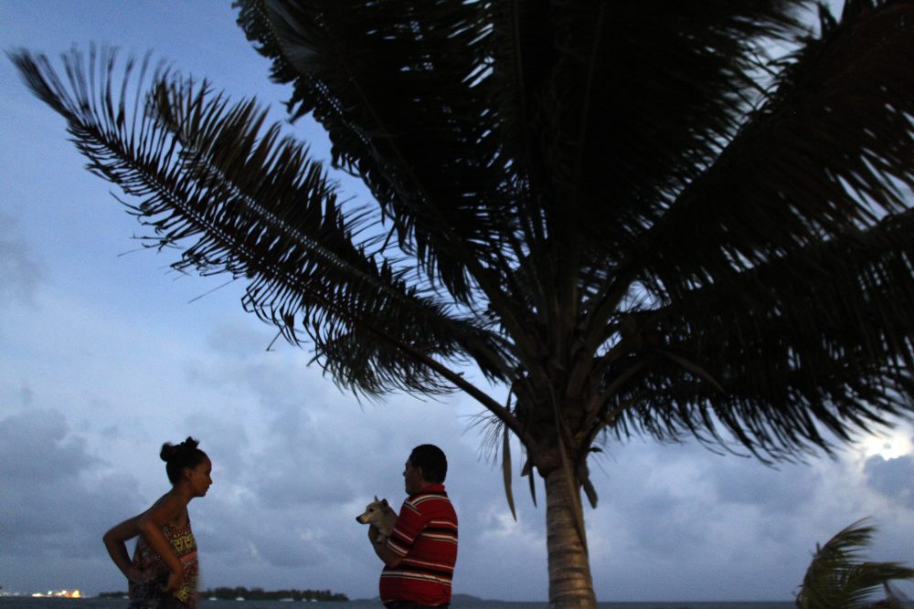 A couple watch the sunset from a seafront as Hurricane Irma approaches Puerto Rico in Fajardo on Sept. 5, 2017. (Ricardo Arduengo/AFP/Getty Images)