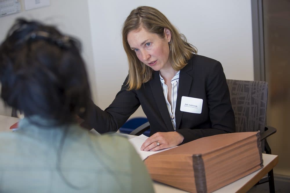 Julie Dahlstrom, director of Boston University's  Law's Immigrants’ Rights &amp; Human Trafficking (IRHT) Program consults with a client who is awaiting an answer about the U visa she applied for two years earlier. (Jesse Costa/WBUR)