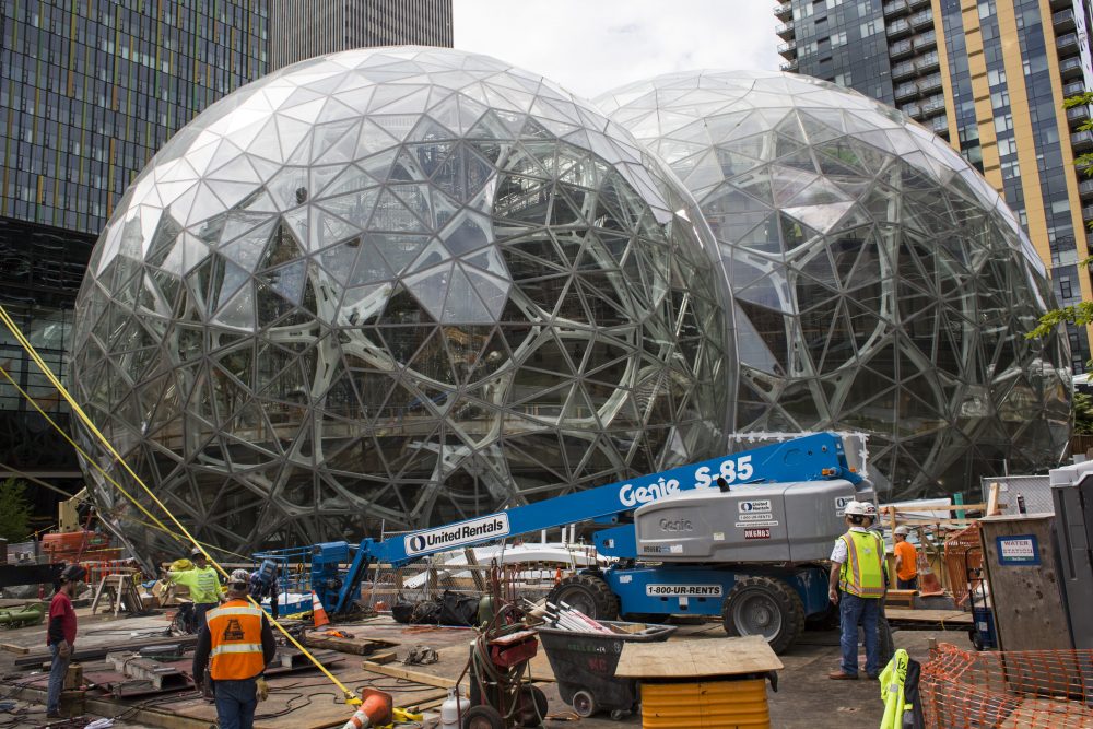Workers surround the signature glass spheres under construction at the Amazon corporate headquarters on June 16, 2017 in Seattle. (David Ryder/Getty Images)