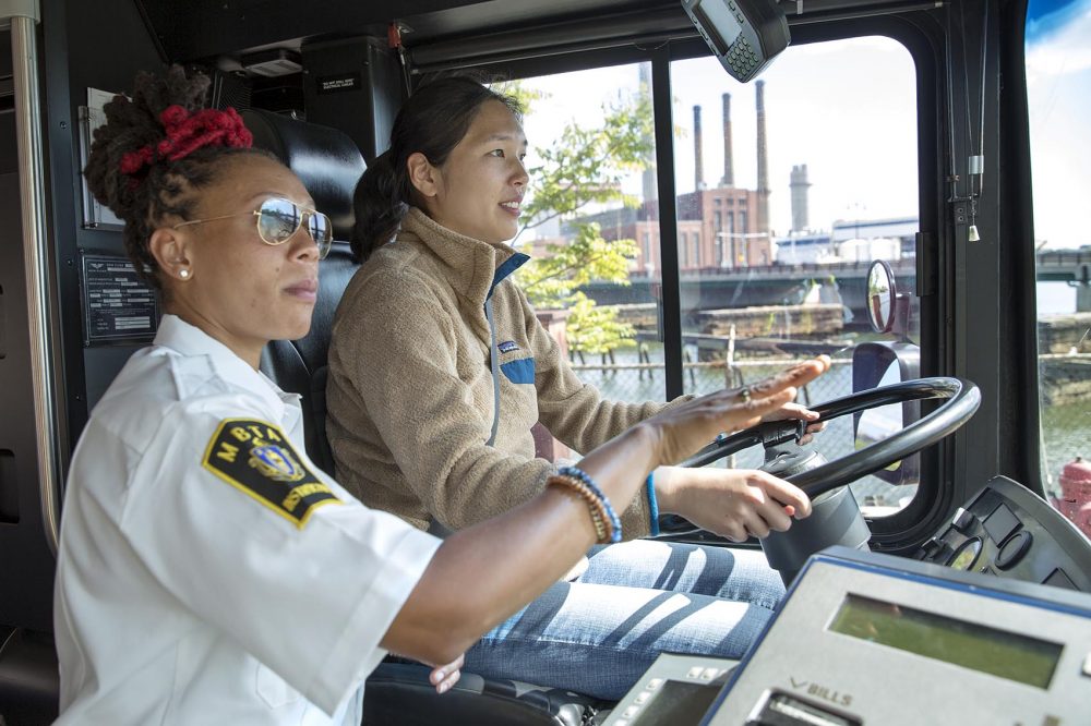 MBTA instructor Shanel Mercer gives Radio Boston's Alison Bruzek a short course on how to drive a bus. (Robin Lubbock/WBUR)