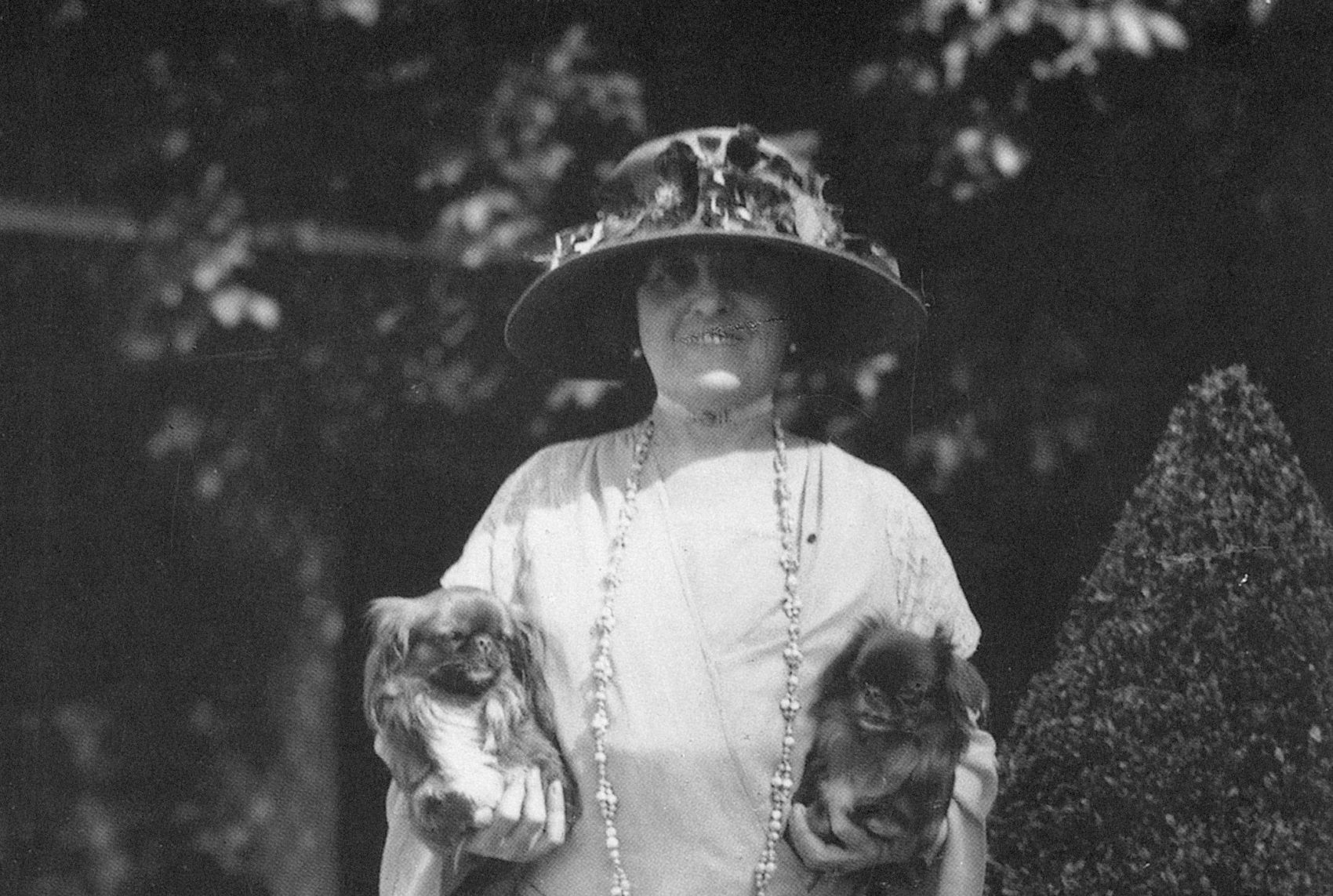 Edith Wharton photographed at her home in France with her two pet Pekingese dogs in the 1920s. (Courtesy Granger Historical Picture Archive/Alamy)