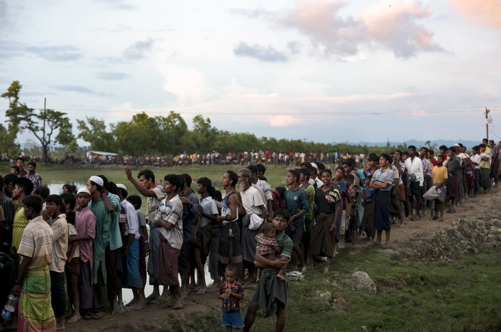 Recently arrived Rohingya refugees wait to receive aid donations on Sept. 13, 2017, in Cox's Bazar, Bangladesh. Around 370,000 Rohingya refugees have fled into Bangladesh since late August during the outbreak of violence in the Rakhine state. (Allison Joyce/Getty Images)