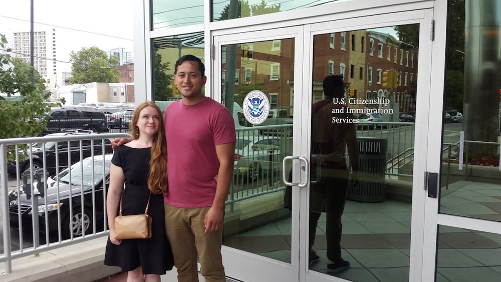 Lillie Williams and Jonatan Palacios stand outside the offices of U.S. Citizenship and Immigration Services in West Philadelphia after completing an interview to determine the legitimacy of their marriage. (Laura Benshoff/WHYY)