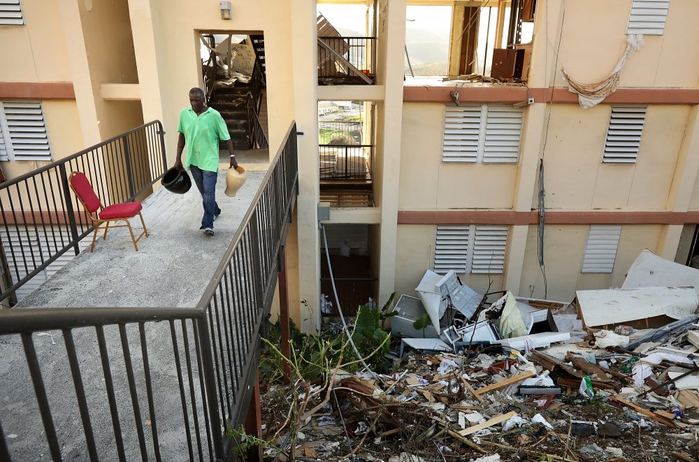 Wentworth Drew carries valuables out of his apartment at the Tutu High Rise after looters broke in after Hurricane Irma destroyed the building, Sept. 17, 2017 in Charlotte Amalie, St Thomas, U.S. Virgin Islands. (Chip Somodevilla/Getty Images)