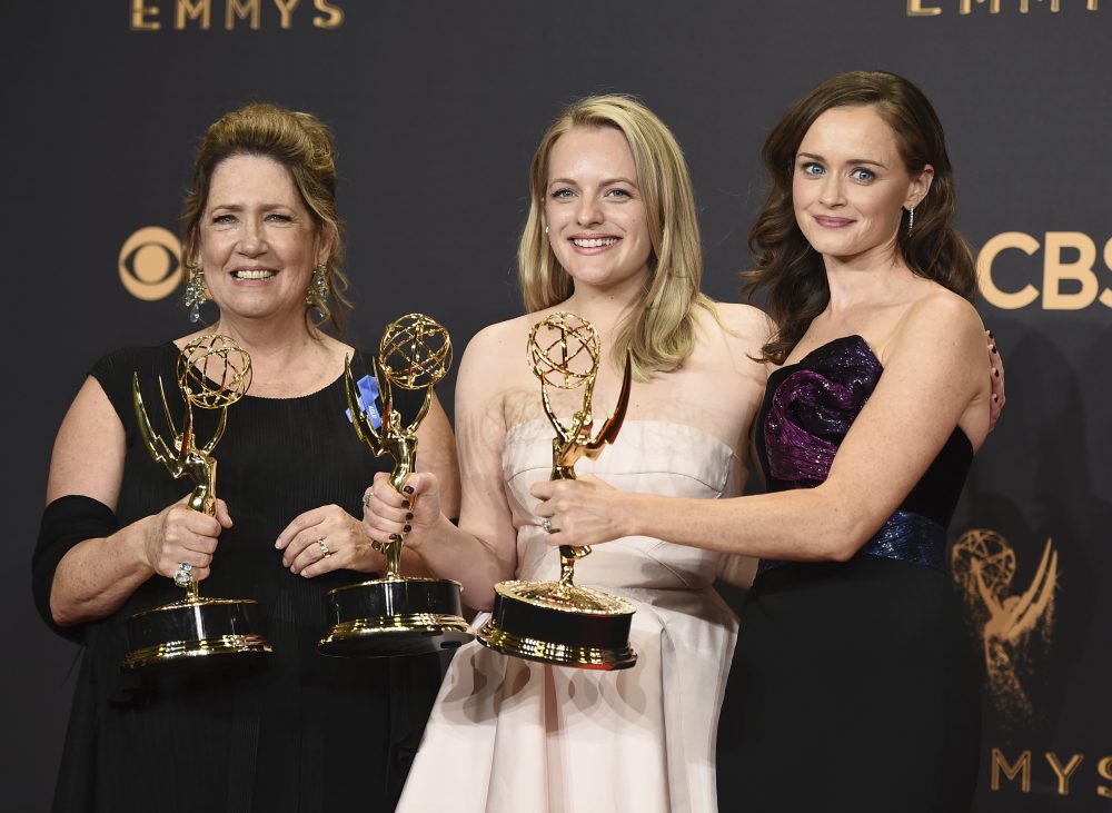 Ann Dowd, from left, winner of outstanding supporting actress in a drama series, Elisabeth Moss, winner of outstanding lead actress in a drama series, and Alexis Bledel, winner of outstanding guest actress in a drama for &quot;The Handmaid's Tale&quot; pose in the press room at the 69th Primetime Emmy Awards on Sunday, Sept. 17, 2017, at the Microsoft Theater in Los Angeles. (Jordan Strauss/Invision/AP)