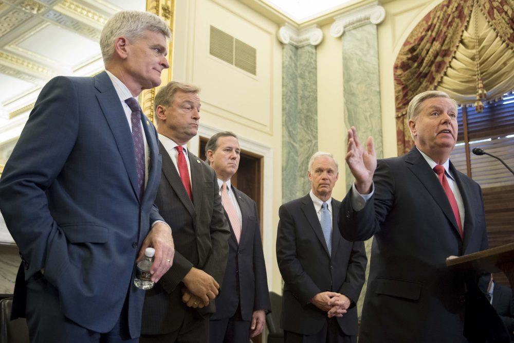 Sen. Lindsey Graham (right), R-S.C., stands with Sen. Bill Cassidy (left), R-La., Sen. Dean Heller (second from left), R-Nev., and Sen. Ron Johnson (second from right), R-Wisc., as well as former Sen. Rick Santorum (center) to announce their legislation to repeal and replace the Affordable Care Act through block grants on Capitol Hill in Washington, D.C., on Sept. 13, 2017. (Jim Watson/AFP/Getty Images)
