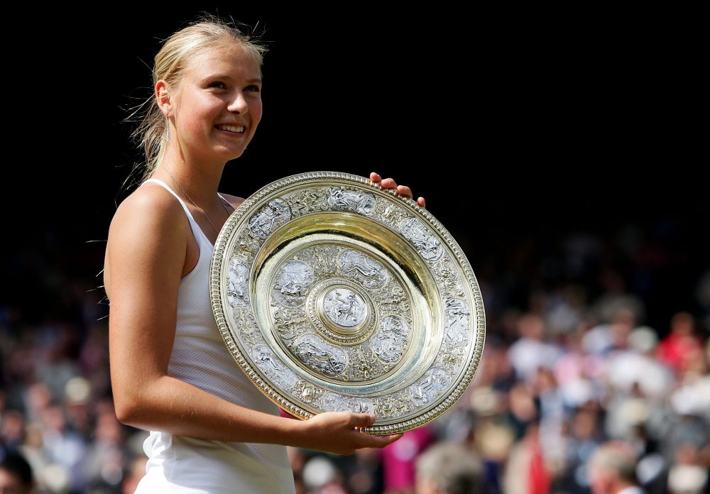 Maria Sharapova poses with the Wimbledon trophy after defeating Serena Williams in the 2004 final. (Mike Hewitt/Getty Images)