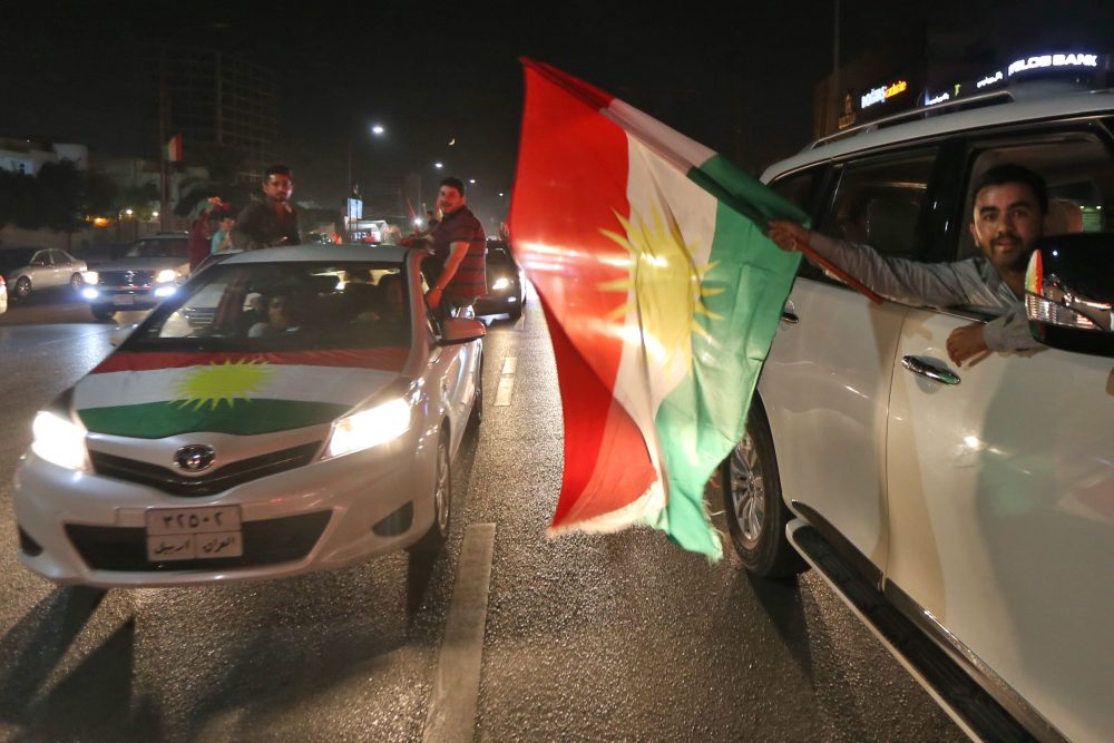Iraqi Kurds wave the Kurdish flag as they celebrate in the streets of the northern city of Irbil on Sept. 25, 2017, following a referendum on independence. (Safin Hamed/AFP/Getty Images)