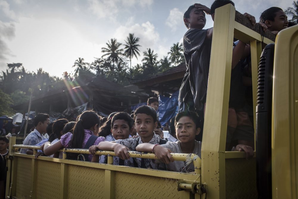 Evacuee children on a truck as they head off to a temporary school on Sept. 27, 2017 in Karangasem regency, Bali, Indonesia. Indonesian authorities declared a state of emergency as hundreds of tremors are recorded at Bali's Mount Agung volcano, and around 90,000 villagers evacuated their homes. Authorities issued travel warnings for the popular tourist destination and warned Mount Agung has the potential to erupt imminently although flights to Bali and its main tourist areas remain unaffected for now. (Ulet Ifansasti/Getty Images)